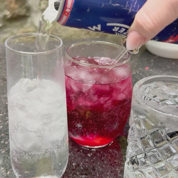 video showing graduation cap drink charm being placed on drink